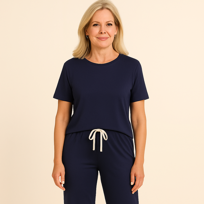 Woman wearing a navy blue outfit with white drawstring on a beige background